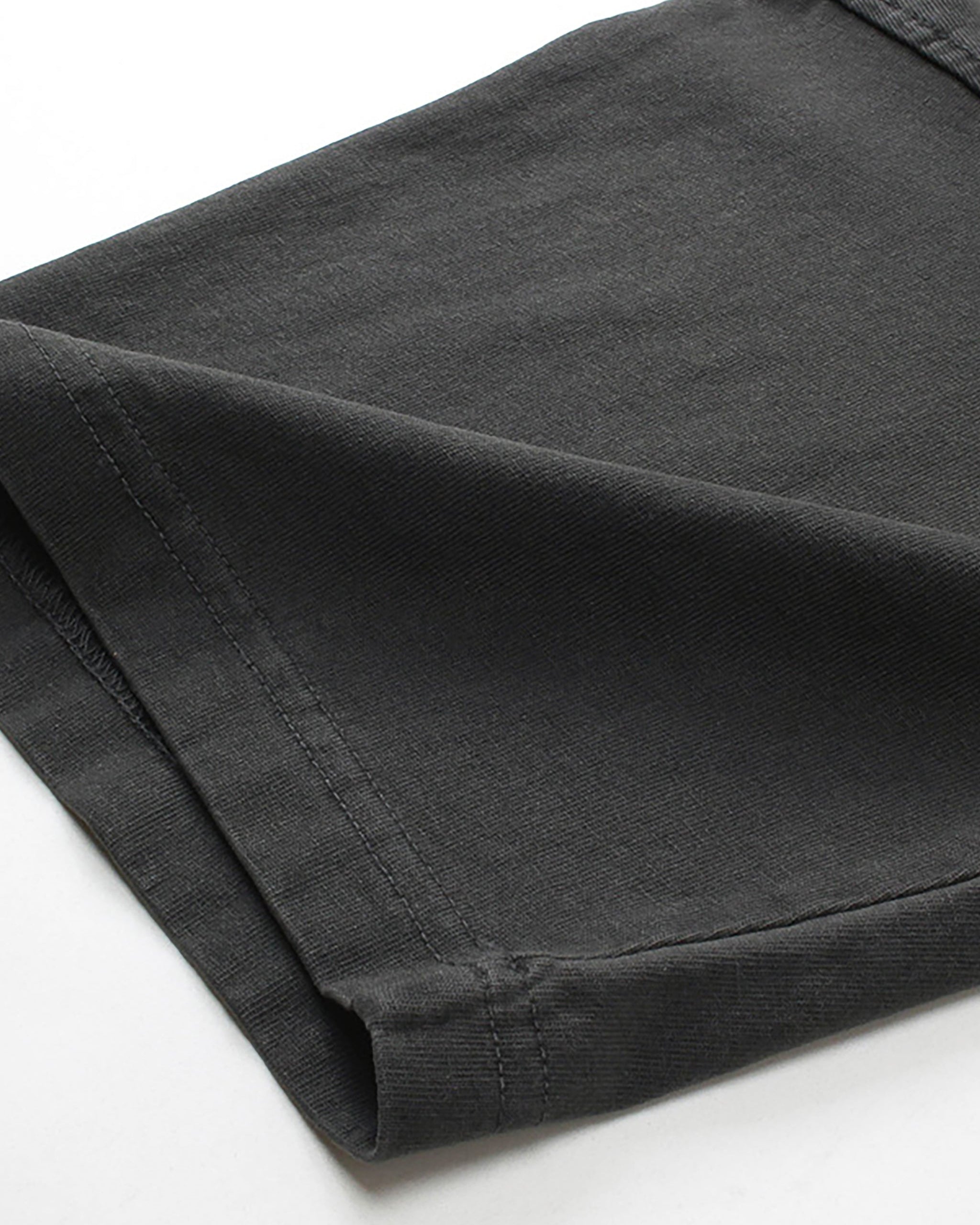 close up of a black t shirt sleeve on a white background